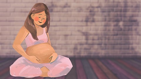 A pregnant woman sitting on the floor