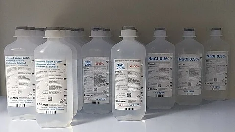 Multiple bottles of sodium chloride solution used for medical purposes.