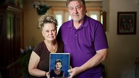 Joy and Tom Higgins hold a photo of daughter Kristin Higgins. A few weeks after Kristin died in 2024, they received a letter stating that any money Kristin left behind would have to be remitted to the state to help repay Medicaid over $4 million.