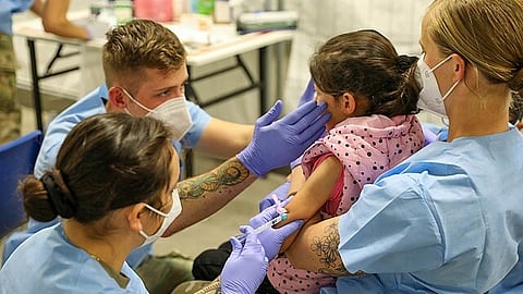A healthcare professional administering the measles vaccine.