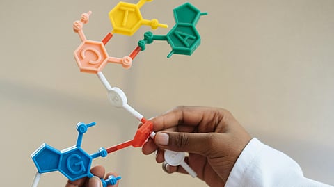 Crop chemist holding in hands molecule model