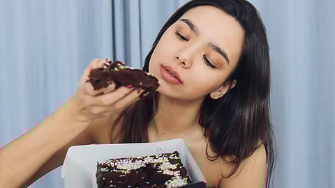 Woman Eating Chocolate Cake