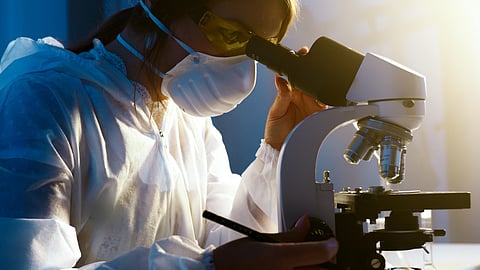 Woman Looking Through Microscope
