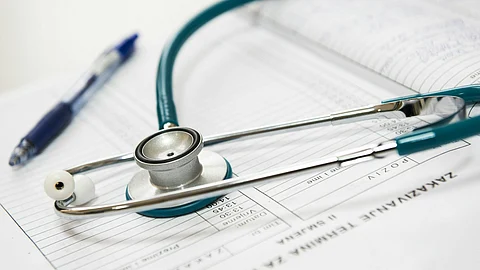 A stethoscope rests on a sheet of paper, symbolizing medical practice and health assessment.