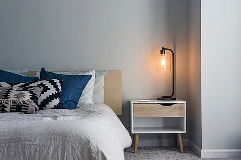 bed and black table lamp on nightstand