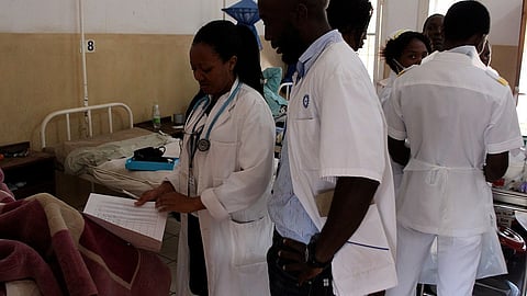 Doctors discussing with a patient.