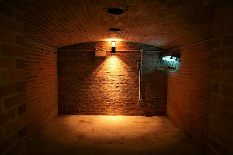 brown brick wall with light bulb in the basement