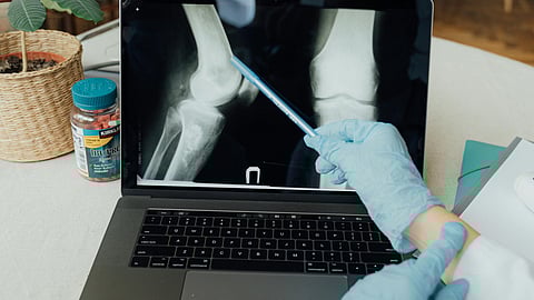 Person Using Macbook Pro on White Table