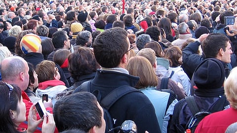 The photograph captures a tightly packed crowd of individuals.