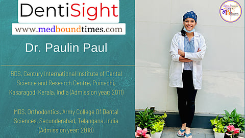 Dr. Paulin wearing a white lab coat, headcap and blue medical mask.