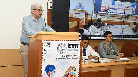 Dr. Rajiv Bahl as a speaker at a podium and several attendees seated at tables.