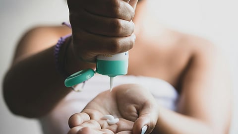 Woman Squeeze Cream Out on Hand