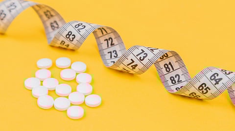 Obesity medication with measuring tape representing weight loss treatment and healthcare access.
