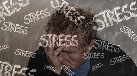 A person experiencing stress, visually represented by the word "STRESS" repeated and overlaid on the image.