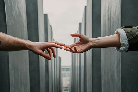 two hands reaching for eachother