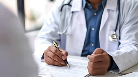 A doctor is writing a prescription.
