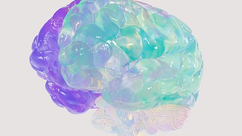 Abstract illustration of human brain in soft hues of blue, teal and purple with a watercolor like texture.