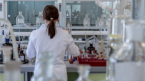 Scientist working in a laboratory setting.