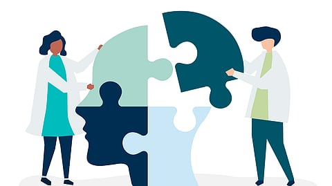 Illustration of two healthcare professionals putting puzzle pieces together to form brain silhouette.