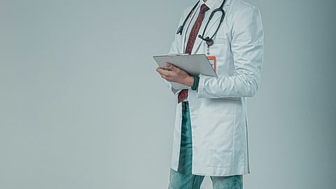 A doctor in a white coat.