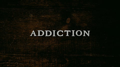 Addiction spelled out on a wooden background