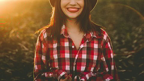 golden hour photography of woman in red and white checkered dress shirt