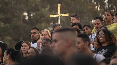Gold Cross is held within a crowd