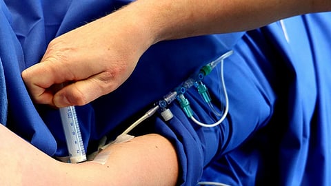 Anesthesiologist administering anesthesia.