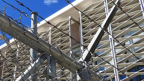 A close-up of a security fence, likely part of a prison.