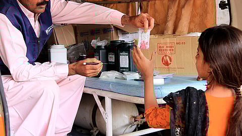 Pharmacist gives medicine to the patient.