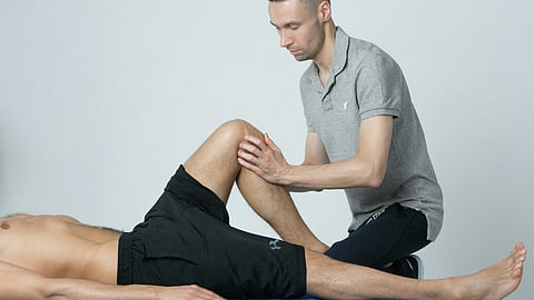 a physiotherapist performing mobilization maneuver