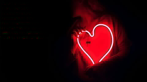 This image represents a person holding heart shaped lights.