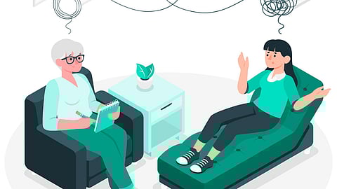 A cartoon illustration of a psychologist and a patient having a discussion in their office.