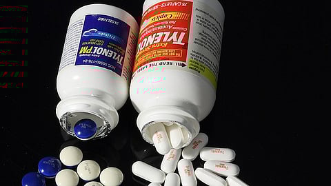 Several pills out from the medicine container