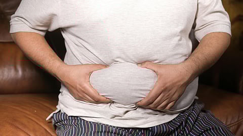 A Man Holding His Tummy