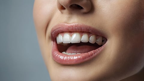 A close-up of a person's mouth with very white teeth.