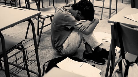 Full shot, sad boy at school