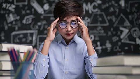The student is thinking about studies in the classroom