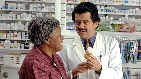 A Pharmacist explaining the patients about the medicines.