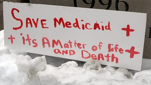 A poster saying 'save medicaid+its a matter of life and death.