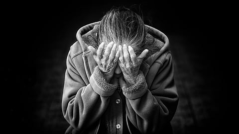 Distressed woman holding her head because of the emotional toll and confusion.