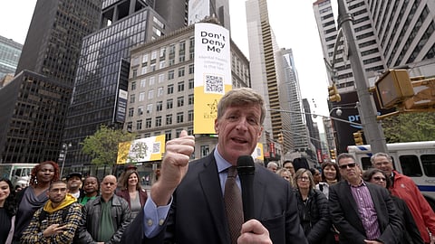 A public gathering in Times square where Patrick Kennedy can be seen speaking through a mic.