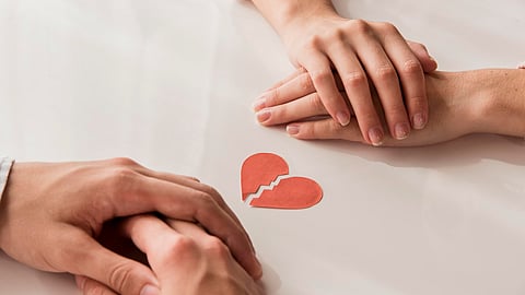 Close-up hands with broken heart