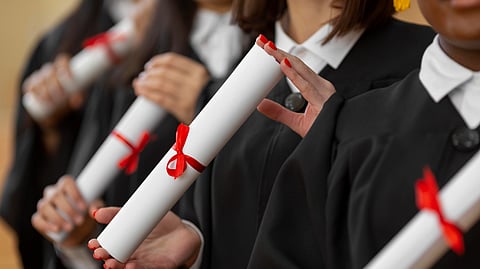 Close up people graduating with diplomas