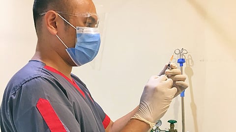 a medical professional preparing a syringe