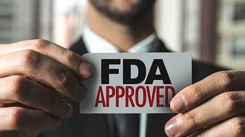 A man showing a fda approved card.