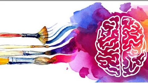 Few color brushes trying to paint a picture over a diagram of brain.