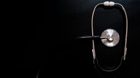 Medical stethoscope isolated with black background.