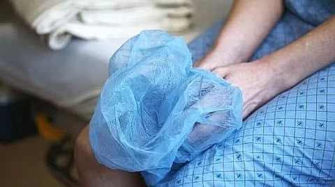 The doctor's hands are being tied by the gown