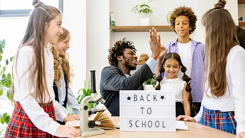 A group of students are happy to come back to school.